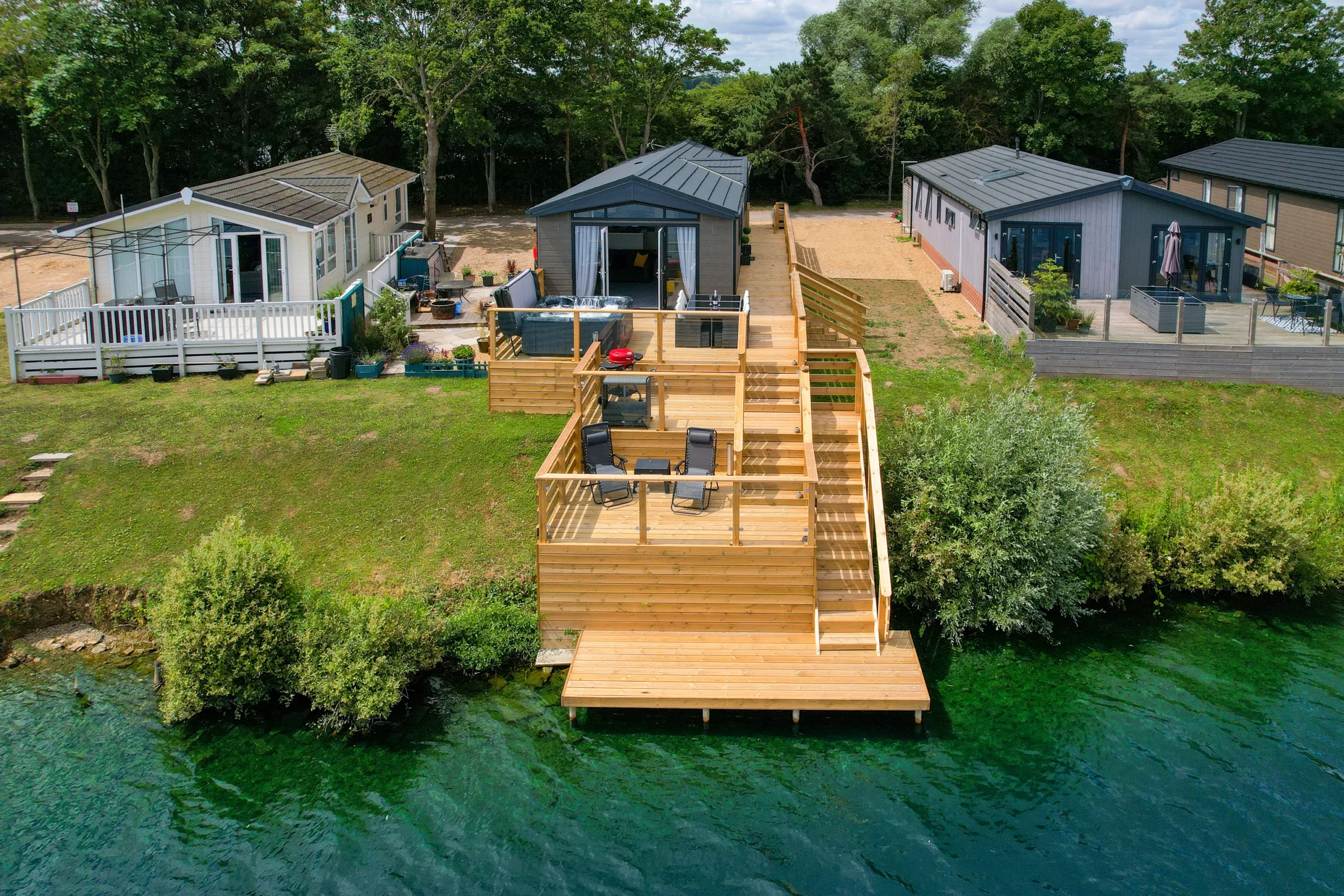 The lodge and decking from above, beside the lake