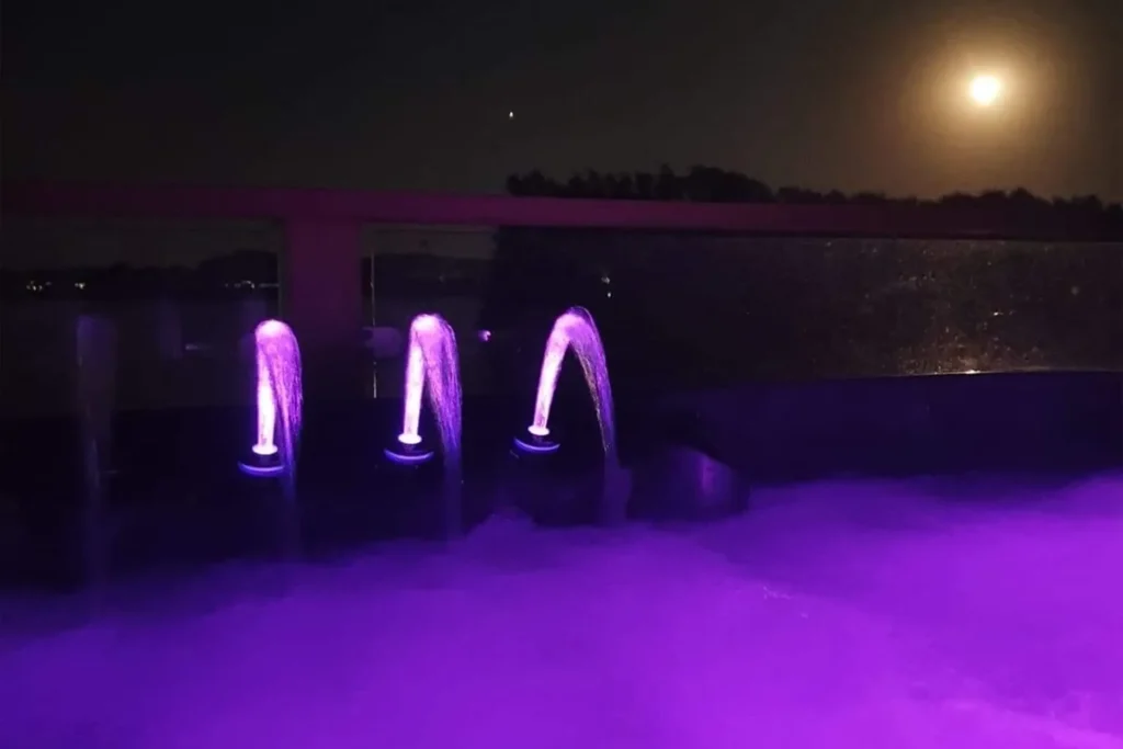 The hot tub lit up at night