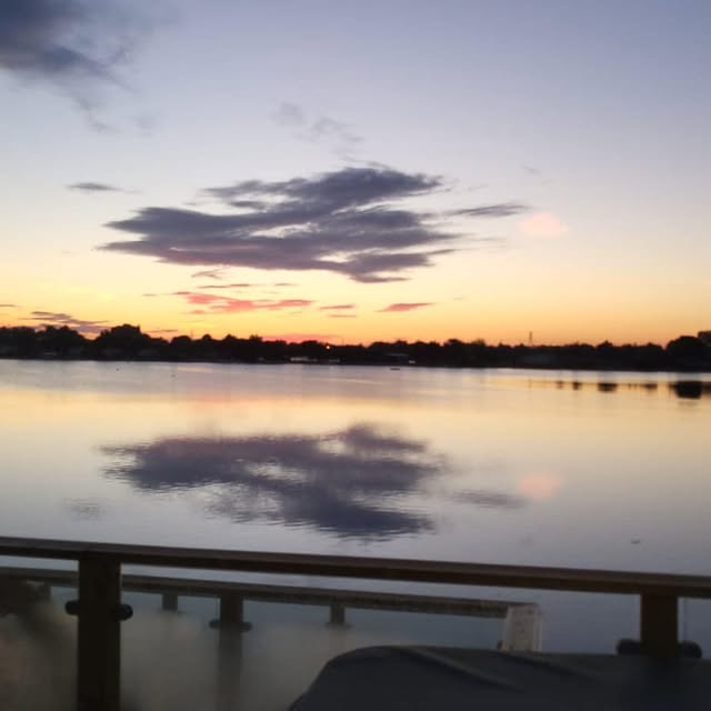 Sunset clouds reflected in the lake from the lodge deck